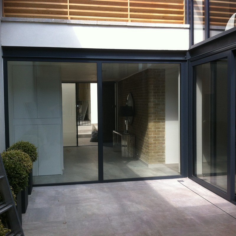 Floor-to-ceiling sliding doors opening to courtyard in Maidenhead