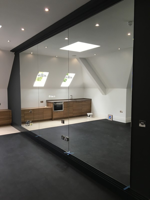 Frameless glass partition in loft conversion by Maidenhead glaziers