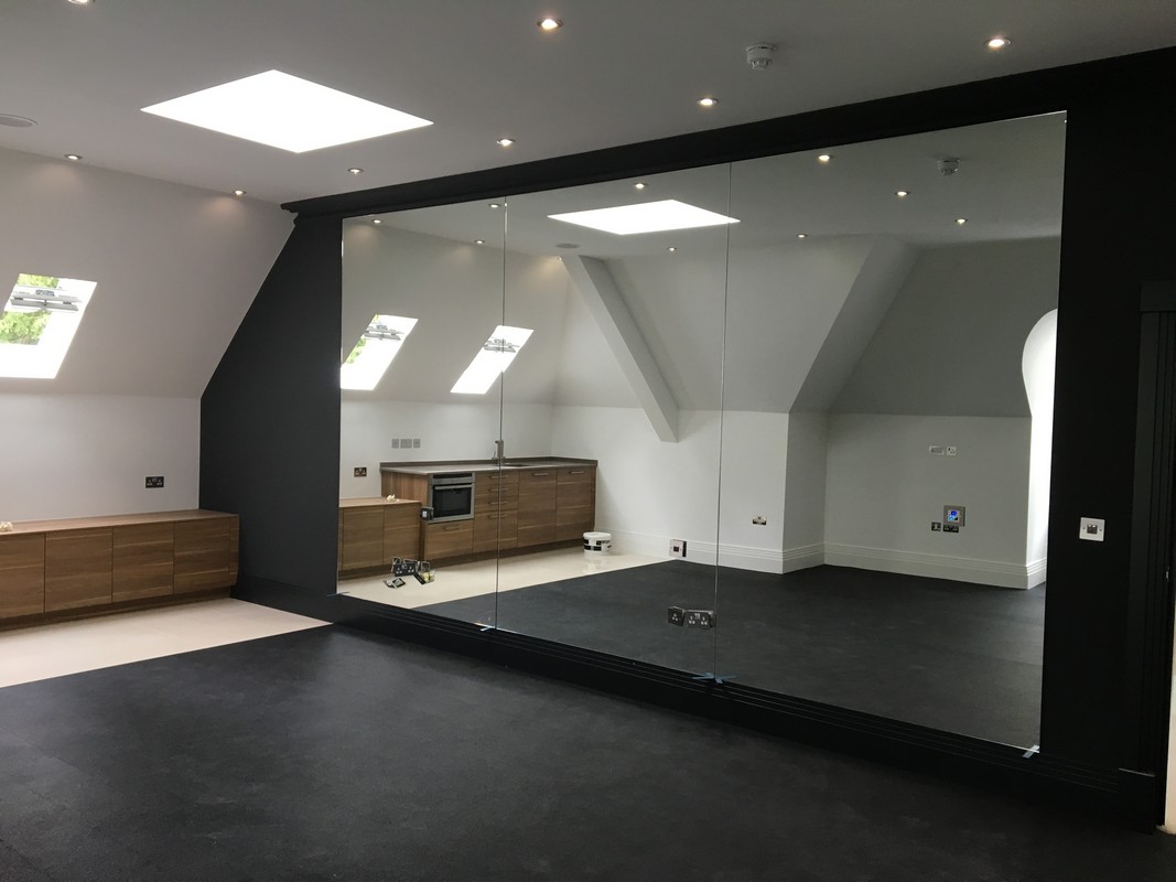 Frameless glass wall dividing loft conversion in Maidenhead