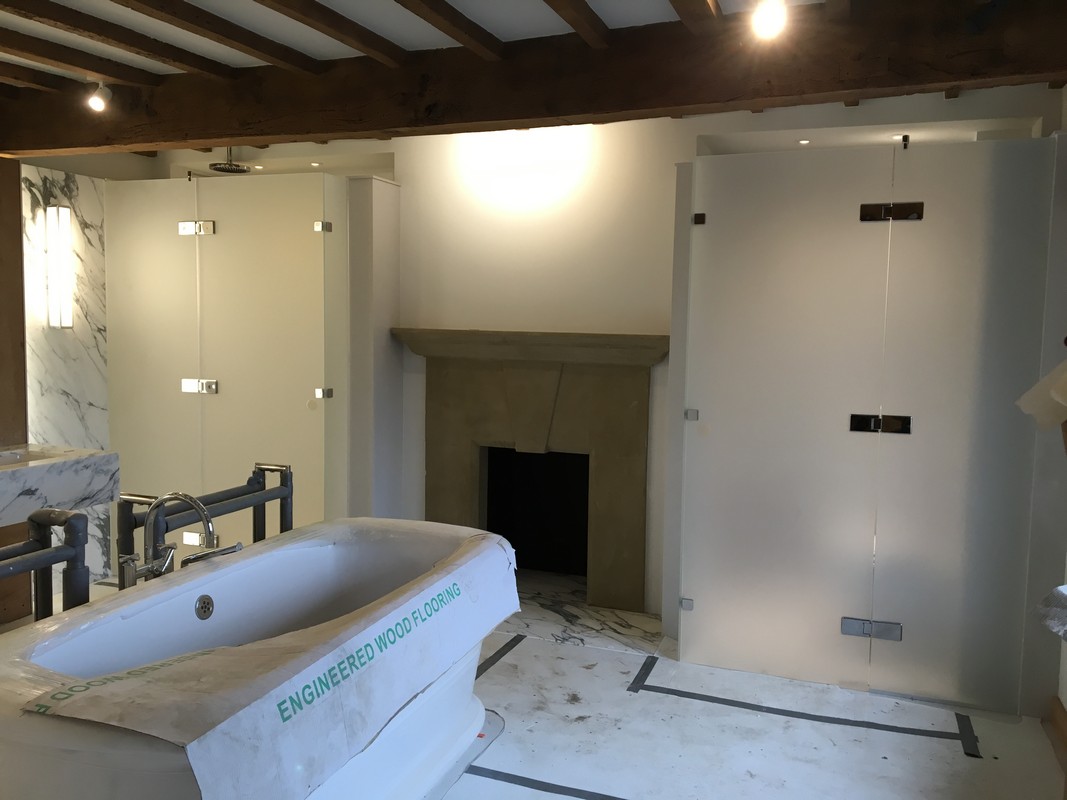 Luxury bathroom with frosted glass shower and exposed beams